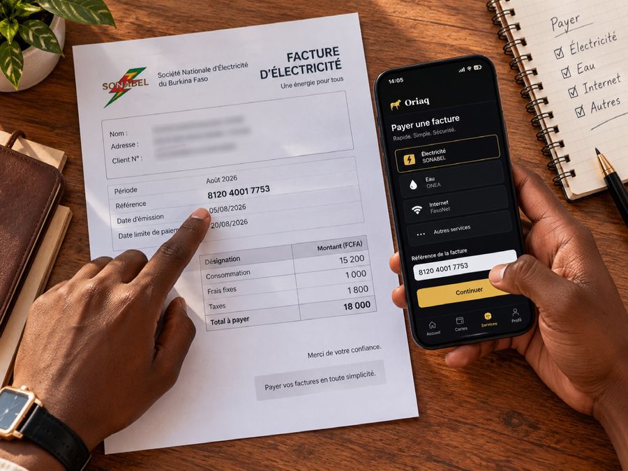 Une facture d'électricité posée à côté d'un téléphone affichant Oriaq